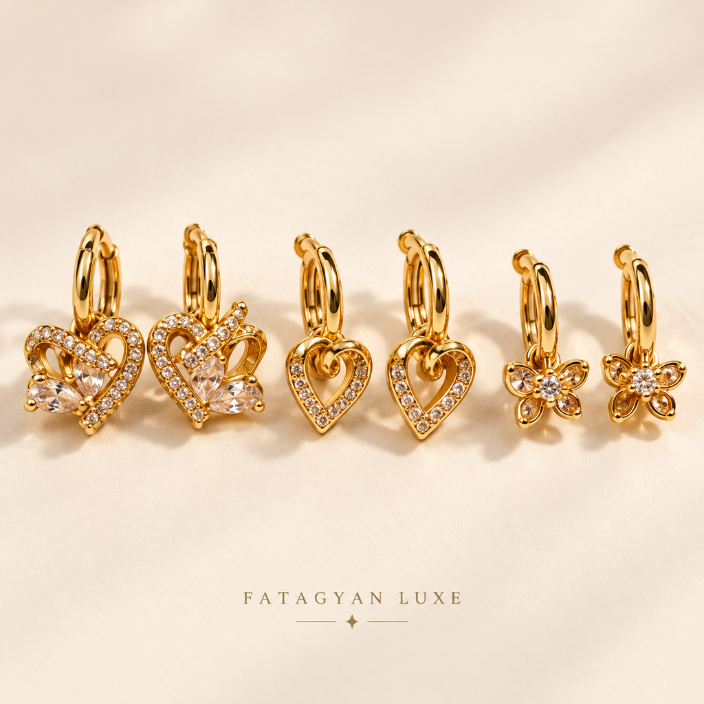 Amour Trio Crystal Huggie Set with three pairs of gold-tone crystal charm earrings