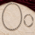 Argent Nexus silver-tone necklace and bracelet jewellery set on stone