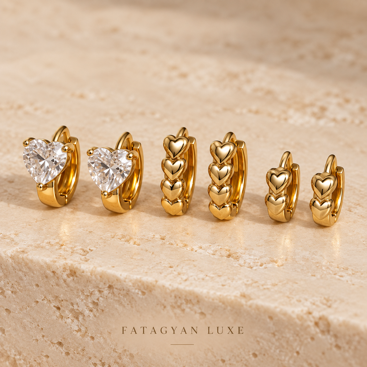 Crystal Amour Trio Huggie Set with three pairs of gold-tone heart earrings