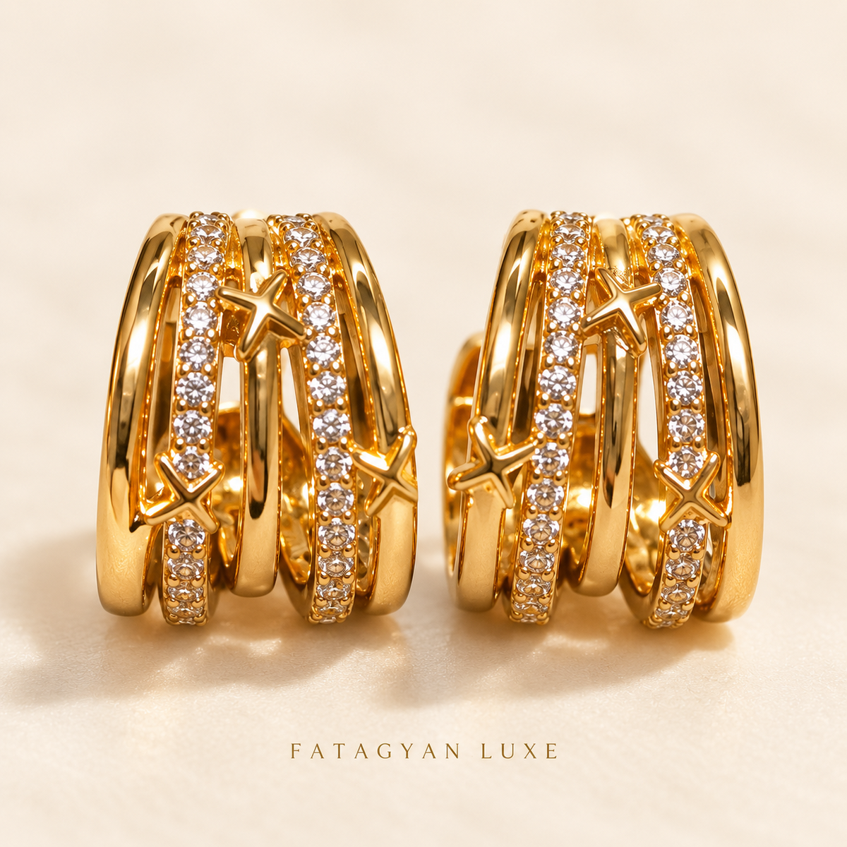 Étoile Orbit Crystal Hoop Earrings in gold tone with pavé crystal bands and star accents