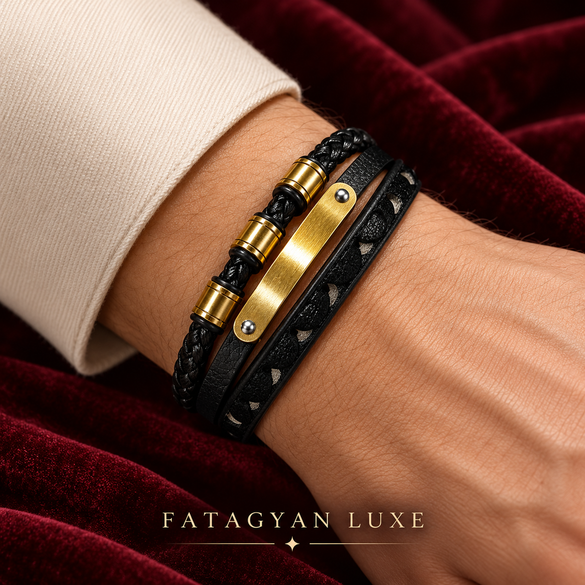 Noir Atlas black layered bracelet with gold-plated front design worn against burgundy velvet