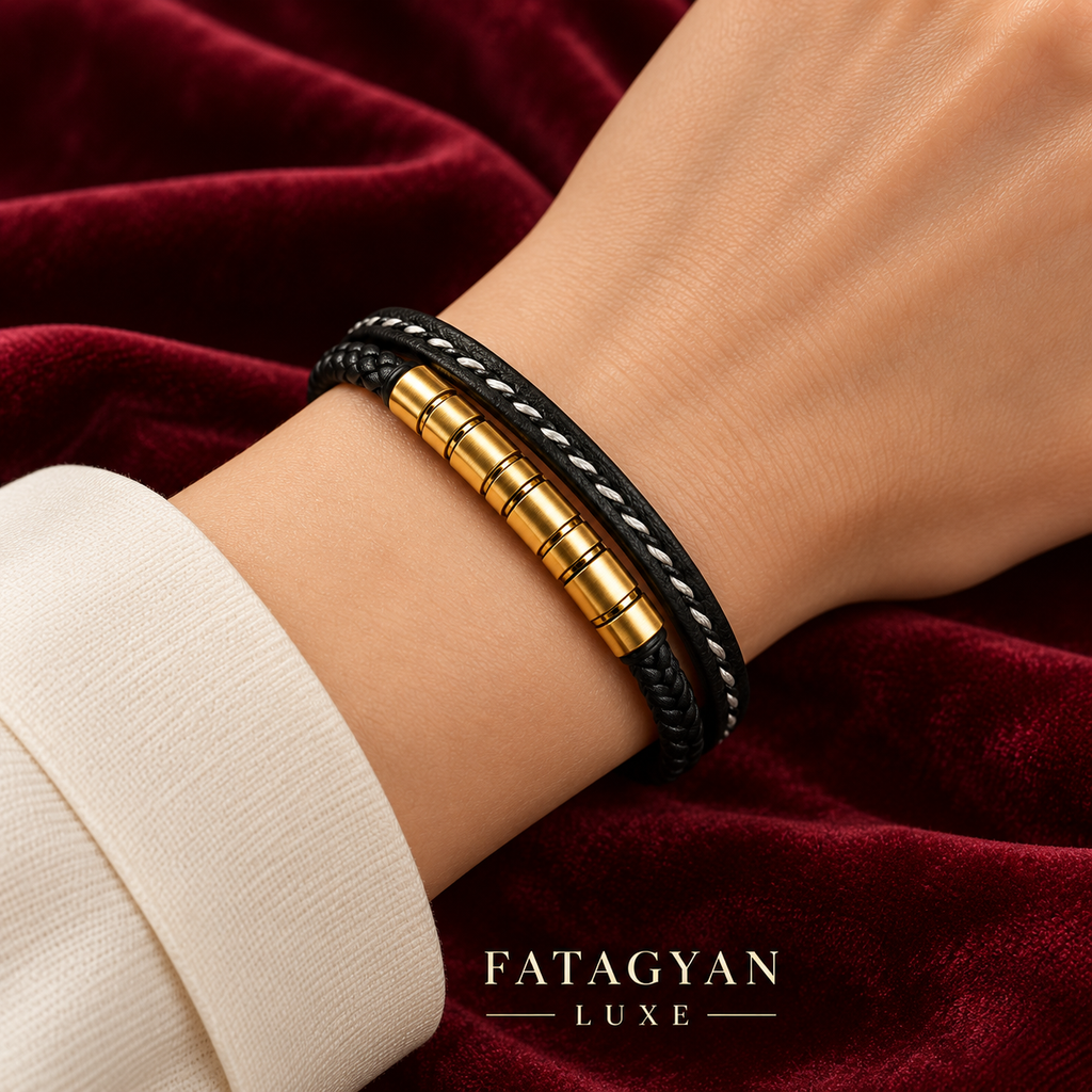 Noir Helix black and gold-plated bracelet worn against burgundy velvet