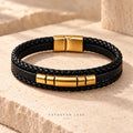 Noir Veritas black braided bracelet with gold-plated accents on ivory stone