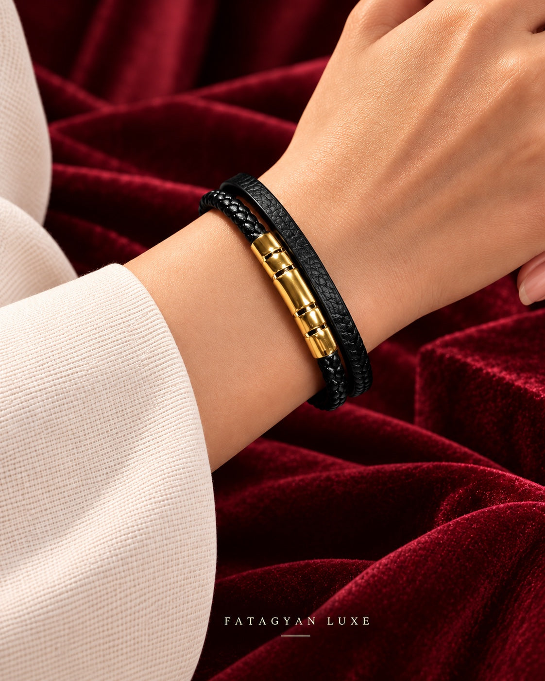 Noir Veritas black braided bracelet with gold-plated front detail worn against burgundy velvet